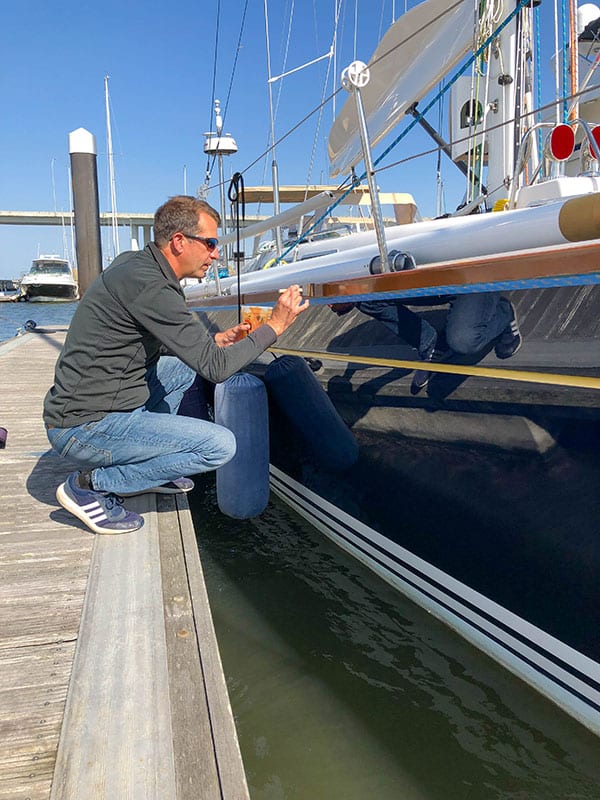Andrew Varnishing Toe Rail Charleston Boat Detailing